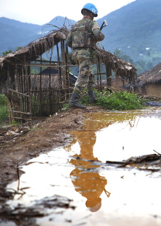 MONUSCO Uruguayan Peacekeepers patrol arrives in Katanga hamlet near Pinga which was the HQ of NDC commander Cheka and was emptied from its entire population until the militia withdrew, the 4th of December 2013. © MONUSCO/Sylvain Liechti