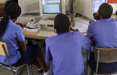Students sit in front of computers in Namibia